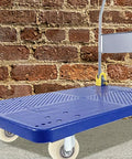 Top Notch 4 Pack 1.5 Inch Nylon Caster Wheels on a blue dolly against a brick wall for smooth movement.