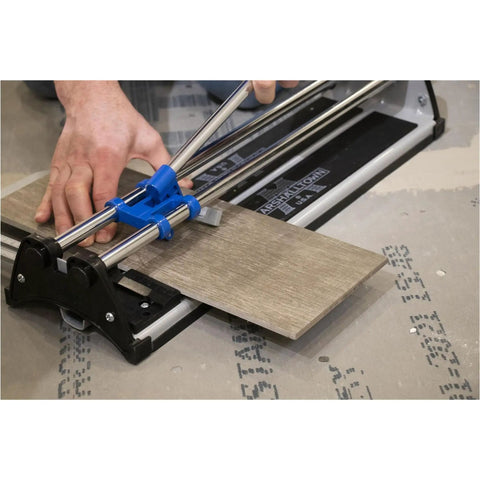 Person using 17 Inch Tile Cutter For Ceramic And Glass Mosaic Tiles, DIY Friendly Tool, cutting a brown tile on a work surface