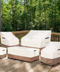 Outdoor furniture covered with beige and brown protective covers on a wooden deck, surrounded by trees.