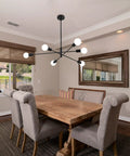 Dining room with Six Light Black Orbital Style Chandelier For Dining Room And Living Spaces, Dope Mid Century Modern Ceiling Fixture