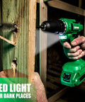 Person using 20V Cordless Drill Set with Battery and Charger, 350 In-Lb Torque to drill into wood with LED light on.