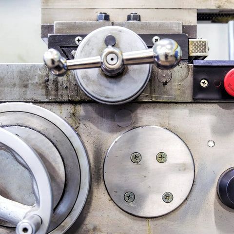 Close-up of industrial machinery with round metal controls featuring Heavy Duty M10 Flange Hex Nut Set Grade 10.9 Carbon Steel.