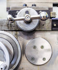 Close-up of a metal machine control panel showcasing M12 Flange Hex Nuts 5 Pack Grade 10.9 Carbon Steel components.