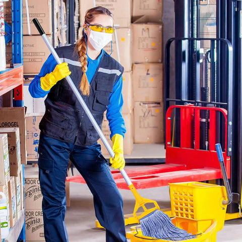 Real Deal Rock Solid Top Shelf Commercial Heavy Duty Wet Mop Heads 6 Pack Looped Cotton String Refills being used for industrial cleaning.