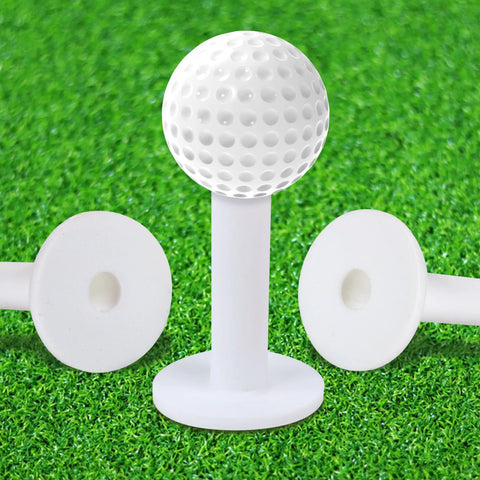 Premium Rubber Golf Tees For Mats And Driving Range 12 Piece Set shown on artificial grass with golf ball on tee.