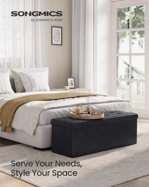 Mazie Collection 43 Inch Folding Storage Ottoman Bench With Hidden Storage Foot Rest Stool in a bedroom setting.