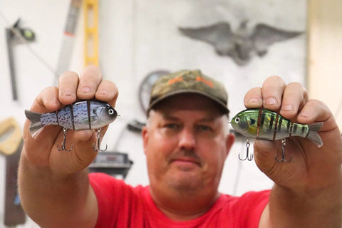 Mike Bucca Baby Bull Gill Swimbait, 3.75 Inch, Three Quarters Ounce Ruby Gill held by person in workshop