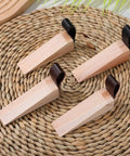 Set Of 4 Wooden Door Stoppers With Non Slip Anti Skid Pads arranged on woven mat