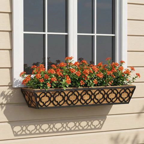 Outdoor metal window box with orange flowers, mounted under a window on a beige wall, part of Adjustable Railing Planter Boxes Set.