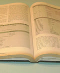 Open book showing pages from 'Hands On PLC Mastery A Practical Pro Guide To Programmable Logic Controllers For Industrial Automation Program Analysis And Development Techniques Second Edition'