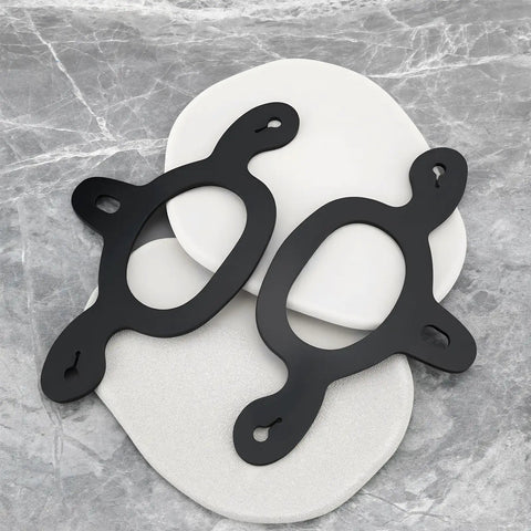Black rubber spur straps tie down set, 4 pcs, shown on a marble surface for training horses, easy to install and durable.
