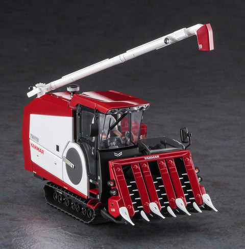 1:35 Yanmar YH6115 Futuristic Combine Harvester Model Kit with multicolored parts on display, showcasing the red and white exterior.