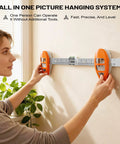 Woman using All In One Picture Hanging Tool That Levels Dead Straight No Sweat Accurately Marks Nail Spots For Frames on wall.