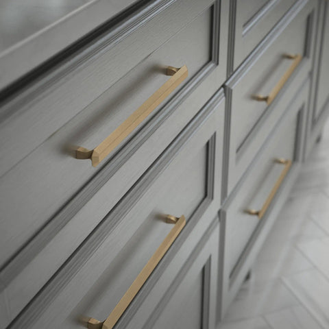 Napier Cabinet Knob Set In Champagne Bronze For Slick Kitchen And Bath Upgrade, 8-13/16 Inch Center-To-Center Drawer Knobs, Durable Zinc Alloy Hardware, 10 Pack installed on gray cabinets