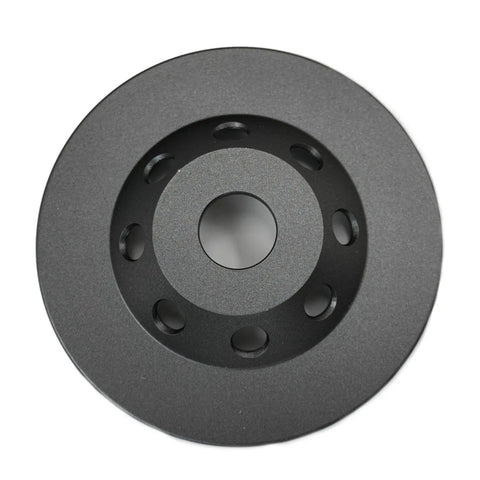 Top view of 5 Inch Diamond Cup Grinding Wheel For Concrete And Coatings Removal, Tackling Paint, Epoxy, Glue, And Mastic With CDB Cluster Diamond Brazing Technology For Fast, Smooth, Pro Grade Surface Prep, showing smooth surface with circular holes.
