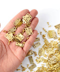 Hand holding 100 Piece Tiny Dollhouse Hinges Set With 180 Degree Mini Metal Hinge Hardware And 400 Screws for wooden projects