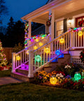 Outdoor Solar Lanterns 2 Pack IP65 Waterproof Hanging Lights With Warm Amber and RGB Glow Crackle Glass Ball Globes on porch railing.