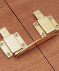 Antique Brass Table Keeper connects heavy table leaves securely with a heavy duty hold on a wooden surface.