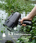 Hand holding 6000 Lumen Waterproof Marine Spotlight with Rechargeable LED Battery, partially submerged in water, showcasing its float capability.
