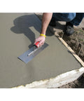 Worker using Concrete Finishing Trowel With A 14 Inch By 4 Inch Stainless Steel Blade And Soft Grip Handle on concrete slab