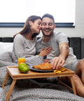 Couple enjoying breakfast in bed on Heavy Duty Velvet Full Bed Frame With Piano Keys Headboard And Matching Footboard, stylish and cozy.