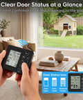 Hand holding remote display of Solar Powered Roll-Up Chicken Coop Door with 400-Foot Wireless Monitoring feature.