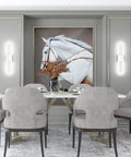 Dining room with large horse painting, surrounded by modern gray chairs, table, and LED wall sconces illuminating the artwork.