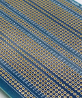 Close-up of One Piece Large Solderable Breadboard Shield For Prototyping Double Sided Tinned Gold Plated Holes Built In Ground Rails