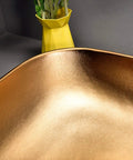 Close-up view of Premium Porcelain Vessel Sink For Above Counter Bathroom Vanity with smooth gold finish.