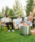 Group enjoying Bonfire Smokeless Fire Pit With Stand, 19.5 Inch Portable Stainless Steel Wood Burning Outdoor Fireplace with Removable Ash Pan in garden