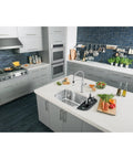 Modern kitchen featuring gray cabinets with Hopewell Steel Bar Pull M993 15 Inch Center-To-Center Flat Black Cabinet Pulls.