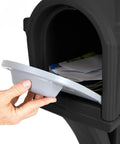 Hand holding a gray mail access door for the Top Grade Classic Black Plastic Residential Mailbox With Standalone Yard Post Mount Combo Kit.