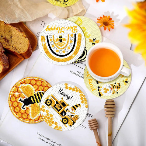 Bee Themed Diamond Painting Coasters Kit With Holder Eight Pattern Coasters Featuring Bee Gnome And Sunflower Designs For Adults DIY Craft Gift Supplies Drill Pen Diamond Tray And Glue Included with bee and sunflower design coasters, cup, and honey dipper on table.