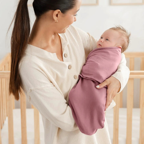 Mother holding baby in Cozy Baby Swaddle Blanket Set Three Pack 100 Percent Cotton Newborn Wraps For 0 To 3 Months in mauve.
