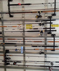 Garage Door Storage Rack for Fishing Gear 21 Inch Black ABS Rod Holder installed on garage door holding fishing rods.