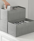 Hand adjusting Three Pack Clothes Organizer Bins With Seven Grid Compartments, Stackable Drawer Dividers For Wardrobe on shelf