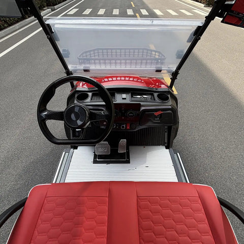 Heavy Duty Six Passenger Electric Golf Cart With Six Point Three Kilowatt AC Motor And Forty Eight Volt Electronics Built In Solar Panels Remote Key Fob And Dope Candy Apple Red Paint For No Sweat Fairway Cruising interior view with steering wheel and red seats.