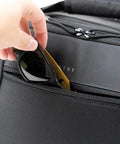 Person placing sunglasses in the front pocket of the Ascend Flight Bag For Pilots: The All In One Carry Bag For Aviation Gear