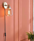 Dope 1 Light Plug In Or Hardwire Wall Sconce In Matte Brass With Smoked Amber Glass Shade And Black Fabric Cord In Line On Off Switch