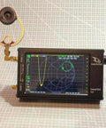 Rad 2 Pack Donut VHF UHF FM Mini Loop Antenna connected to DeepVNA device displaying frequency graph.