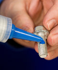 Applying medium strength blue threadlocker to threaded fastener