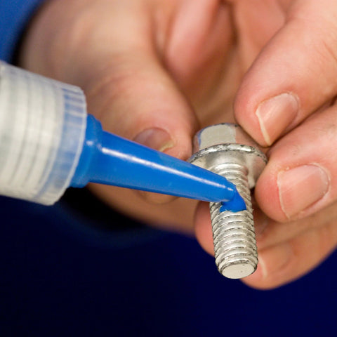 Applying medium strength blue threadlocker to threaded fastener