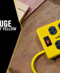 Heavy Duty Metal Power Block With Four Grounded Outlets, Lighted Switch, Four Foot Yellow Cord, 14 Gauge, Built In 15 Amp Circuit Breaker For Rugged Workshop Use shown on a wooden surface