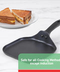 Specialty Nonstick Mini Griddle 6.5 Inch Pan with sandwich beside, even heat base, black cookware on marble surface. Safe for all cooking methods except induction.