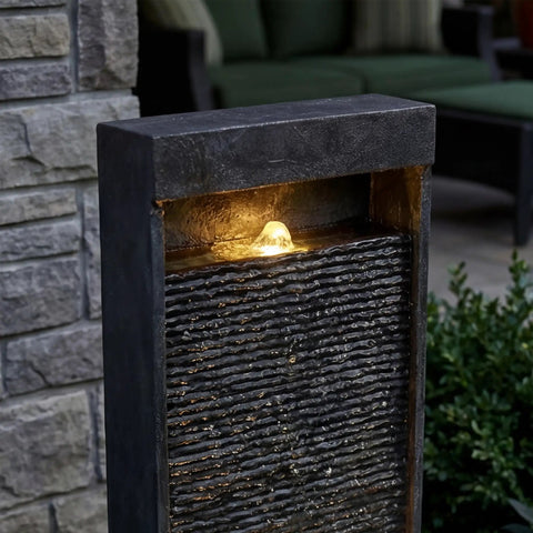 35 Inch Outdoor Water Fountain With Modern Curved Faux Slate Resin Waterfall And 2 Warm LED Lights For Garden Patio Yard Deck Porch Balcony Decor Home Art Water Feature In Black Keeps Your Outdoor Vibe On Point, showing illuminated water flow.