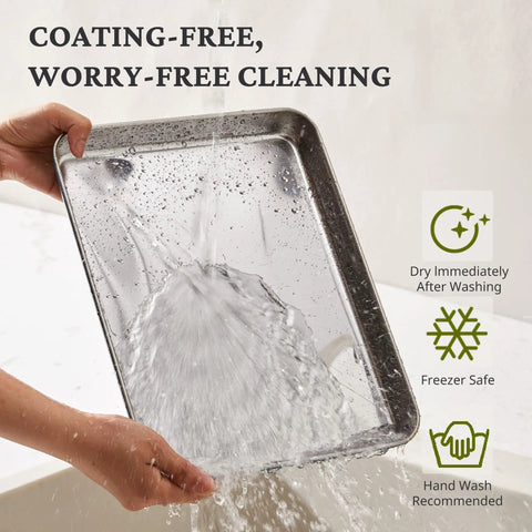 Person rinsing a stainless steel baking pan from the Stainless Steel Baking Sheet Set With Wire Racks Includes 3 Pans And 3 Racks In 9 12 16 Inch Sizes Non Toxic PFOA PTFE Free Warp Resistant Durable Oven And Toaster Safe Navy Finish For Go To Everyday Baking, showing water hitting the surface.