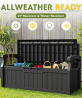 80 Gallon Outdoor Storage Bench With Armrest Lockable Deck Box in black, open showing contents, on grass with garden tools nearby.