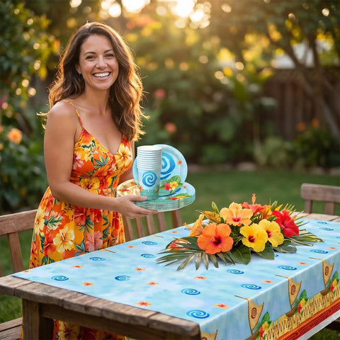Woman setting table with Tropical Island Party Supplies Set For 10 Guests With Polynesian Style Disposable Tableware for kids birthday luau.