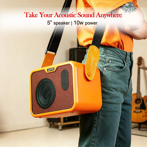 Person holding Compact 10W Acoustic Guitar Amplifier With 15 Foot Cable Bundle For Portable Practice Battery Powered Dual Channel