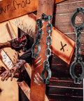 2 Pack Plastic Halloween Fake Prison Chains With Handcuffs And Footcuffs For Realistic Prisoner Look displayed against a spooky backdrop